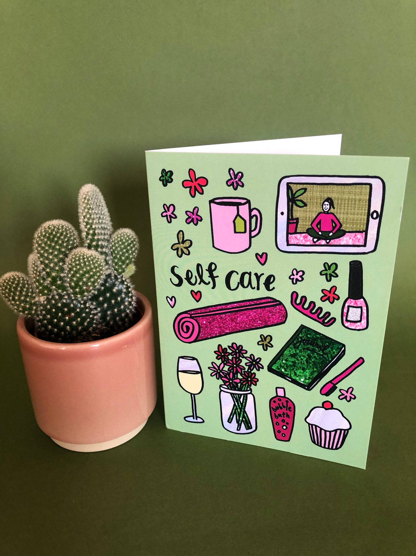 Everyday greetings card that says 'self care' and features a fun pattern of self care items 