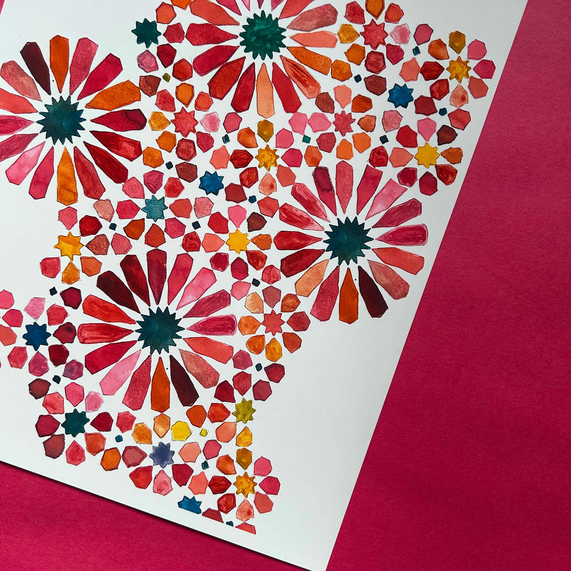 Colourful geometric pattern on a white background with a red border