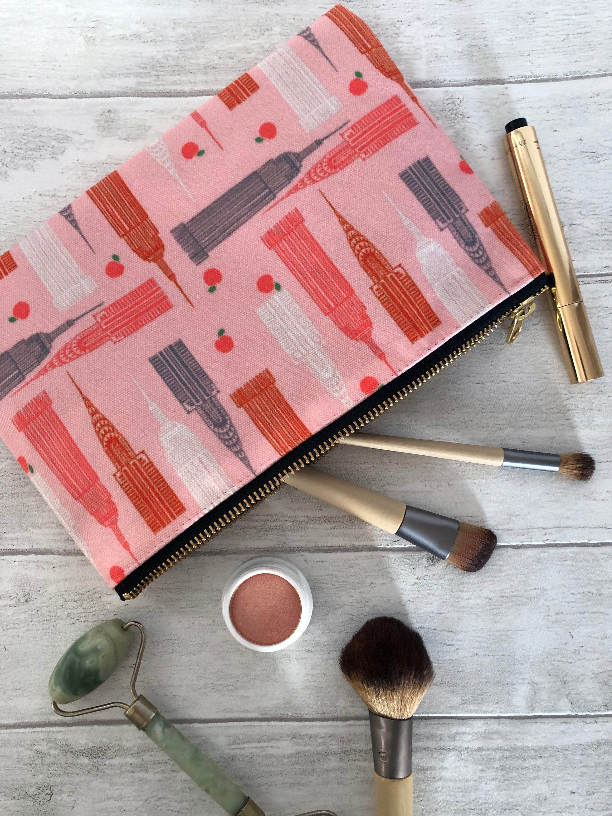Handy zip pouch in pastel pink featuring a unique design inspired by the skyscrapers of NYC 
