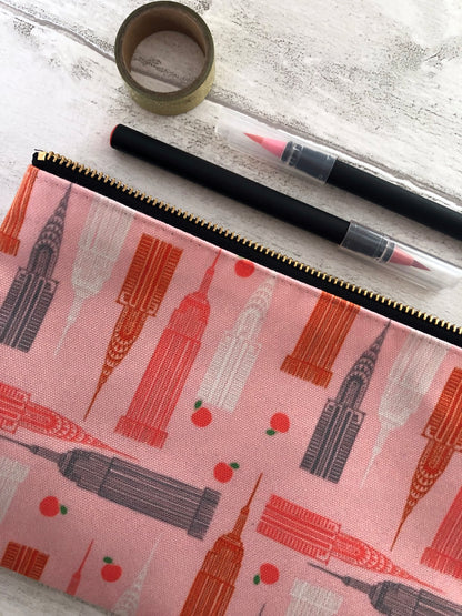 Handy zip pouch in pastel pink featuring a unique design inspired by the skyscrapers of NYC 