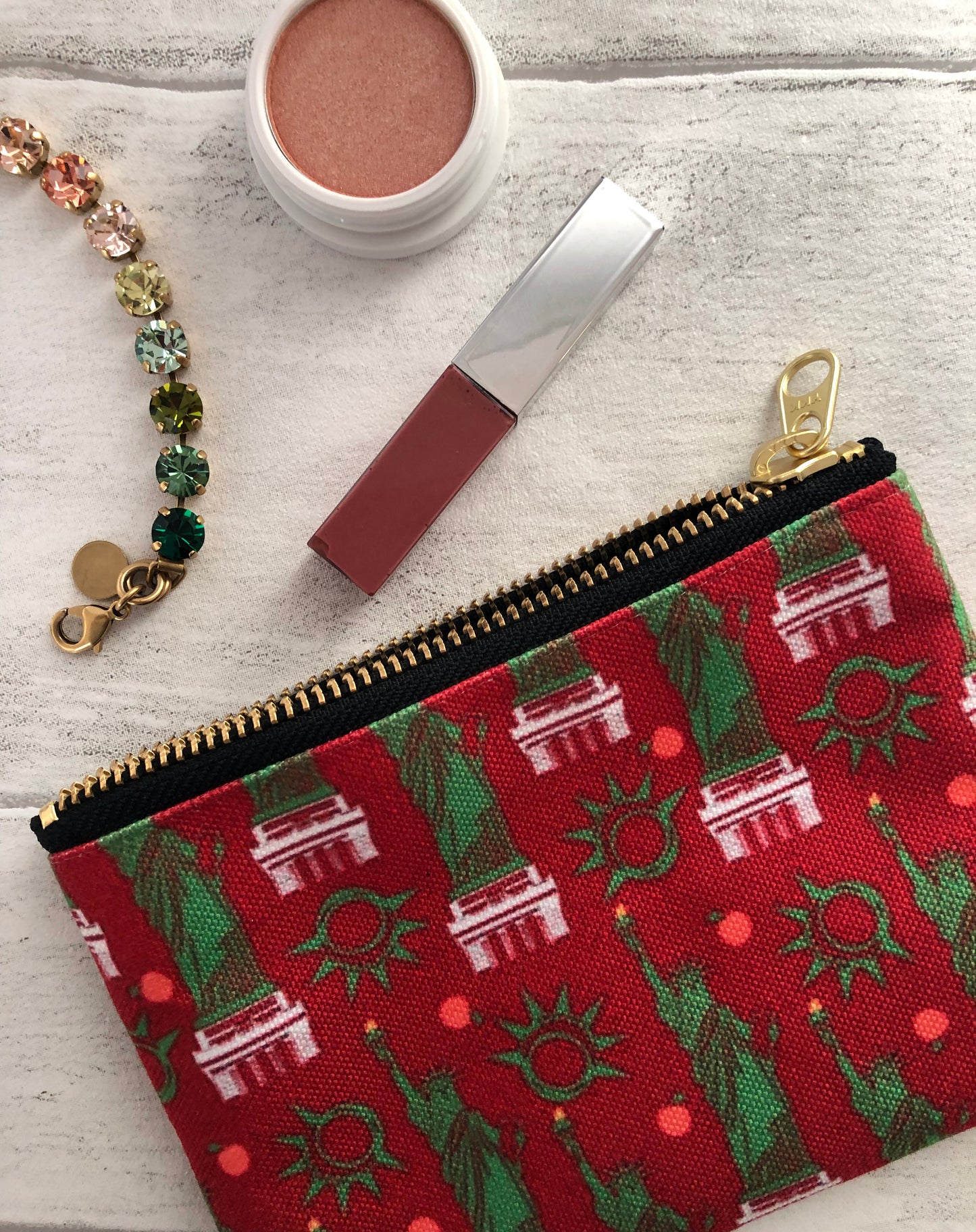 Handy zip pouch in a bold red colour with a statue of liberty design