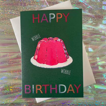 Image shows a green birthday card with a pink collaged jelly and 'Happy Birthday' in colourful lettering.