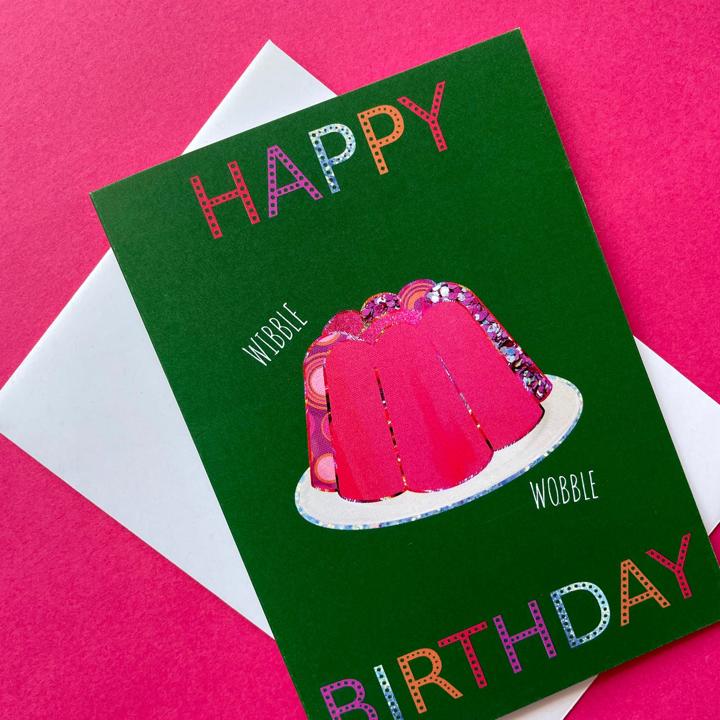 Image shows a green birthday card with a pink collaged jelly and 'Happy Birthday' in colourful lettering.