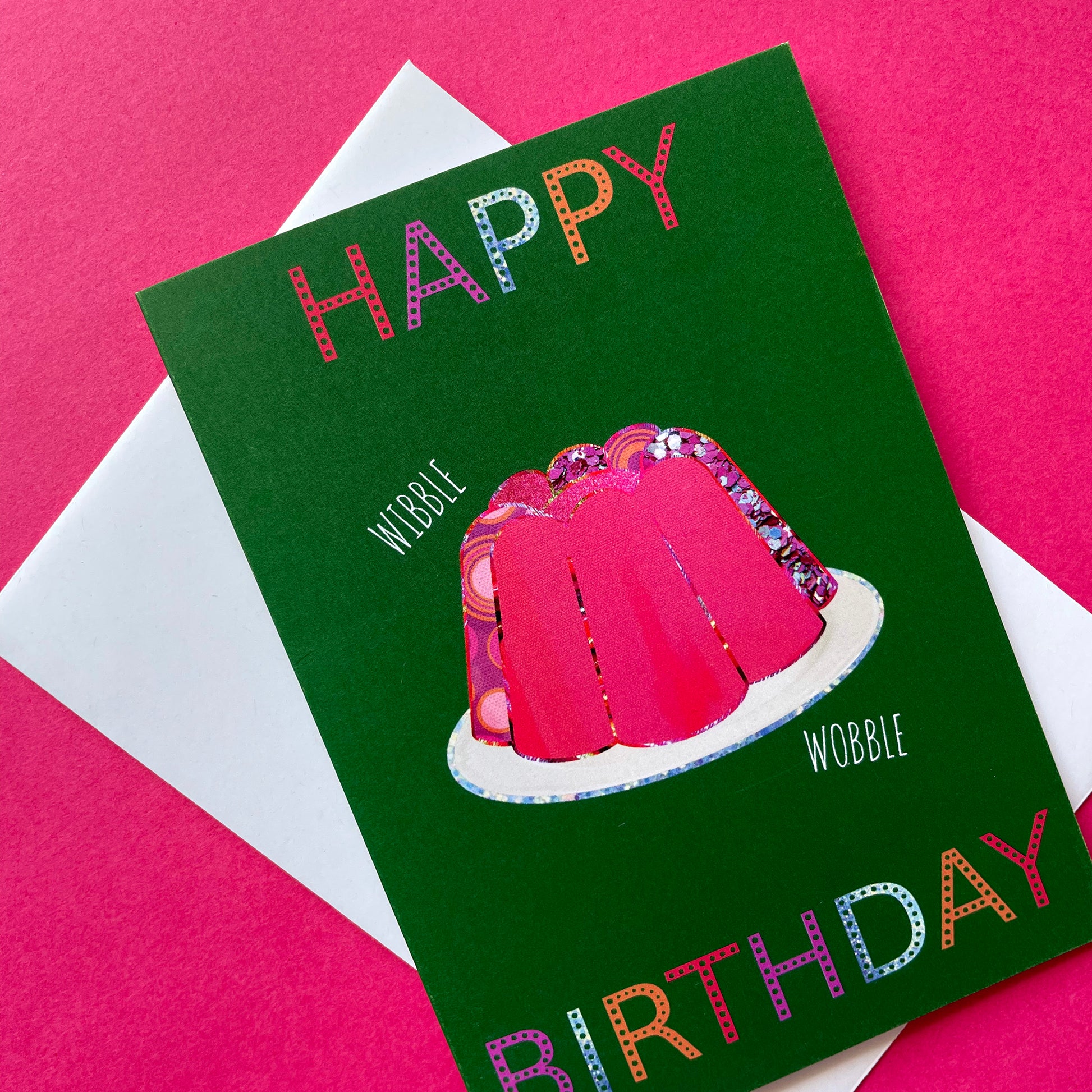 Image shows a green birthday card with a pink collaged jelly and 'Happy Birthday' in colourful lettering.