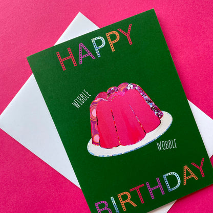 Image shows a green birthday card with a pink collaged jelly and 'Happy Birthday' in colourful lettering.