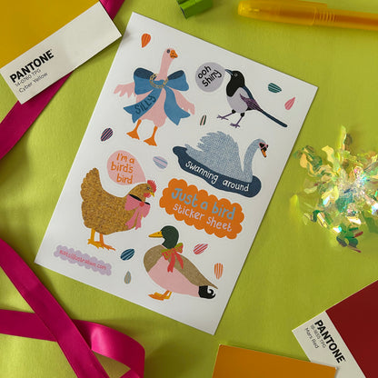 Sheet of bird-themed stickers on a green surface with Pantone swatches.