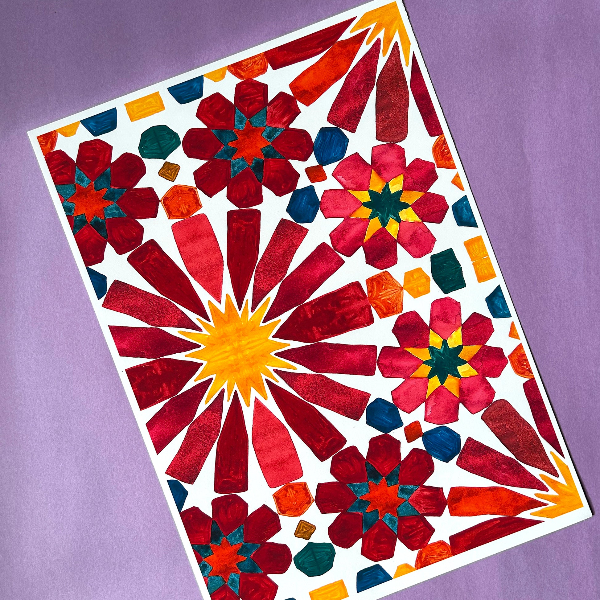 Colourful geometric pattern on a white sheet against a purple background