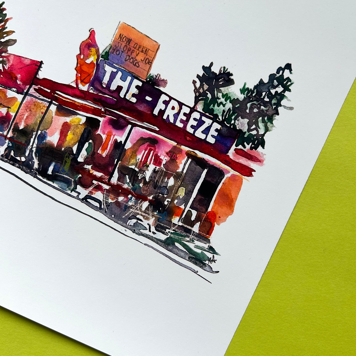 Artistic depiction of a building with 'The Freeze' sign on a white background