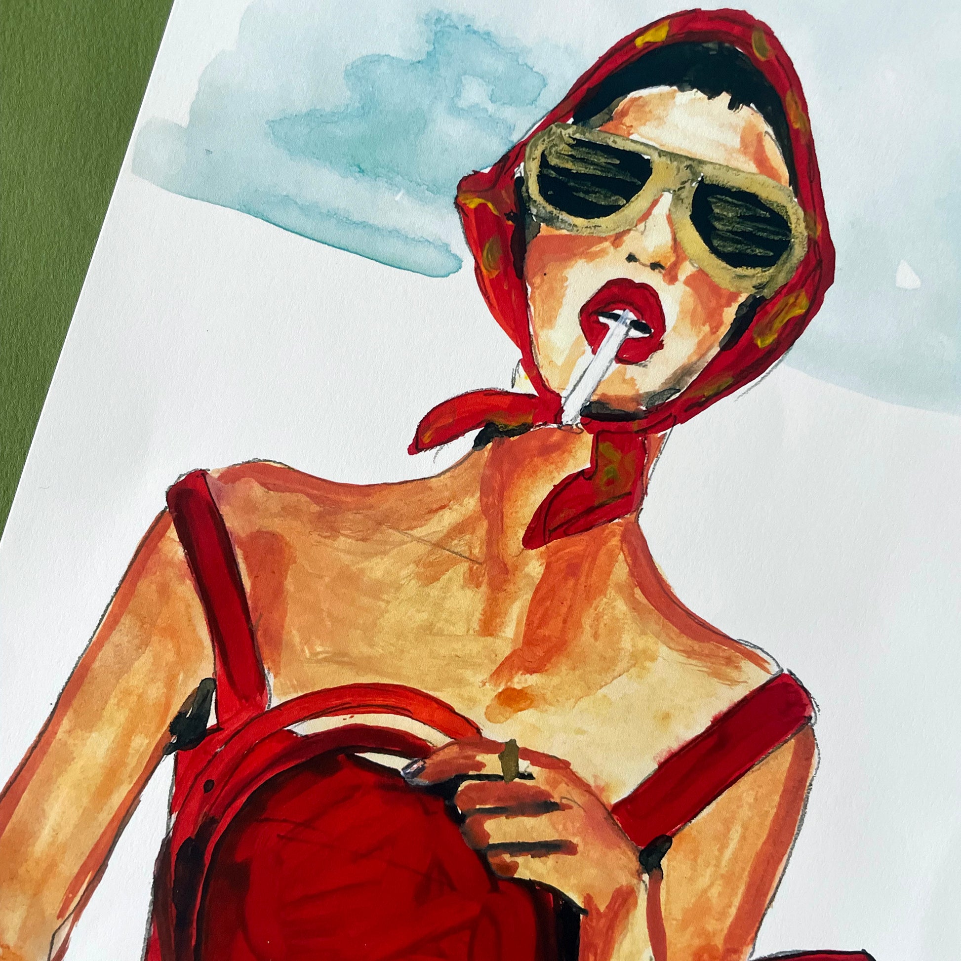 Image shows a framed illustration of a woman in a red dress and headscarf, holding a red bag and smoking with gold sunglasses on