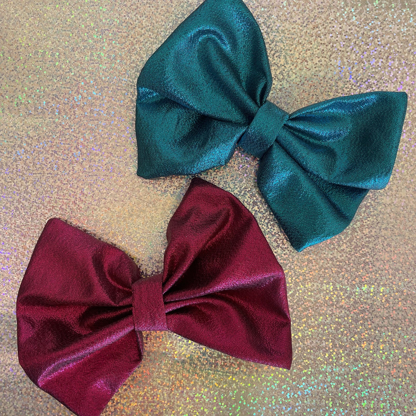 Image shows a blue metallic hair bow made from high quality lamé fabric.