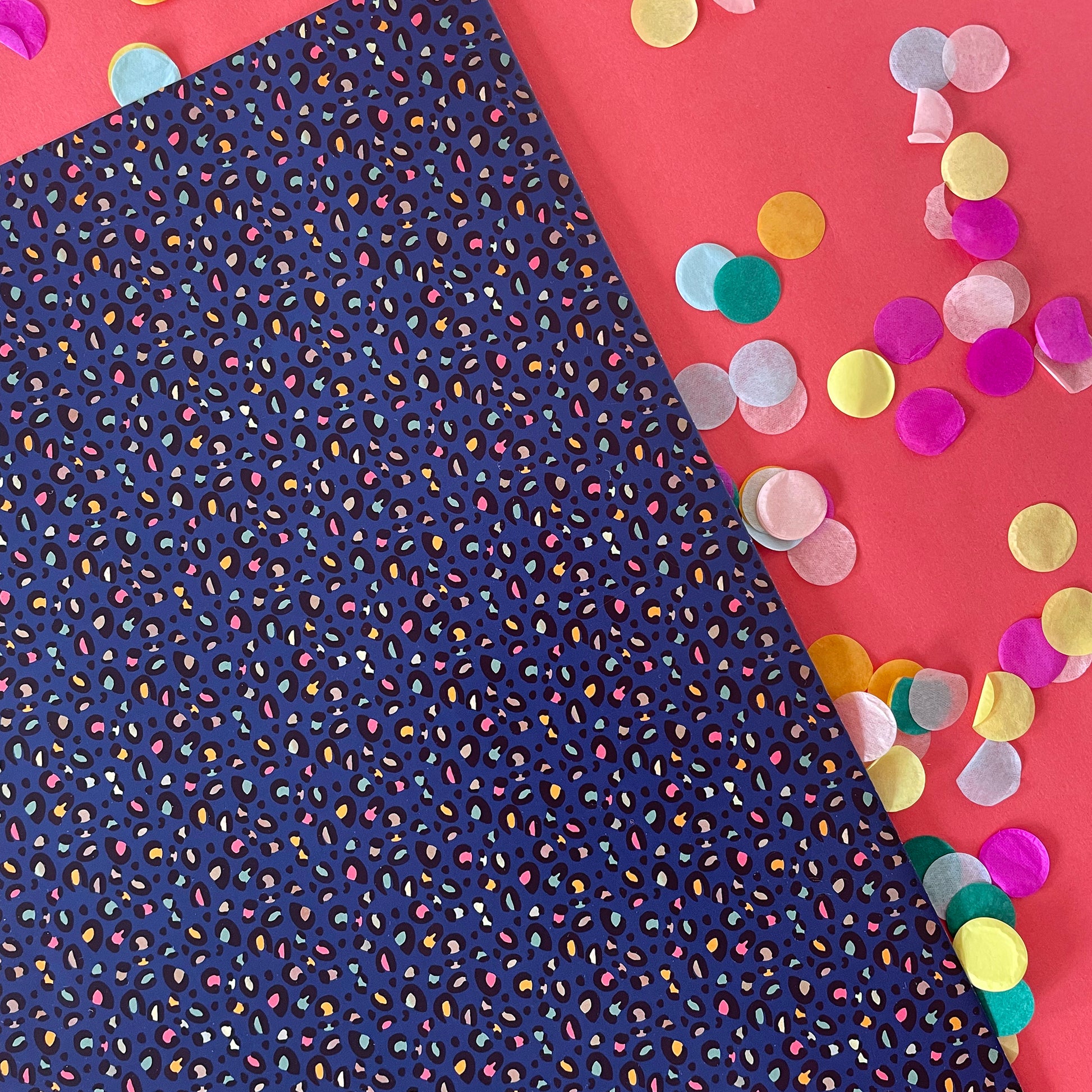 Image shows a stunning midnight blue wrapping paper featuring a stylish leopard print.