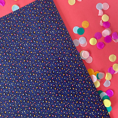 Image shows a stunning midnight blue wrapping paper featuring a stylish leopard print.