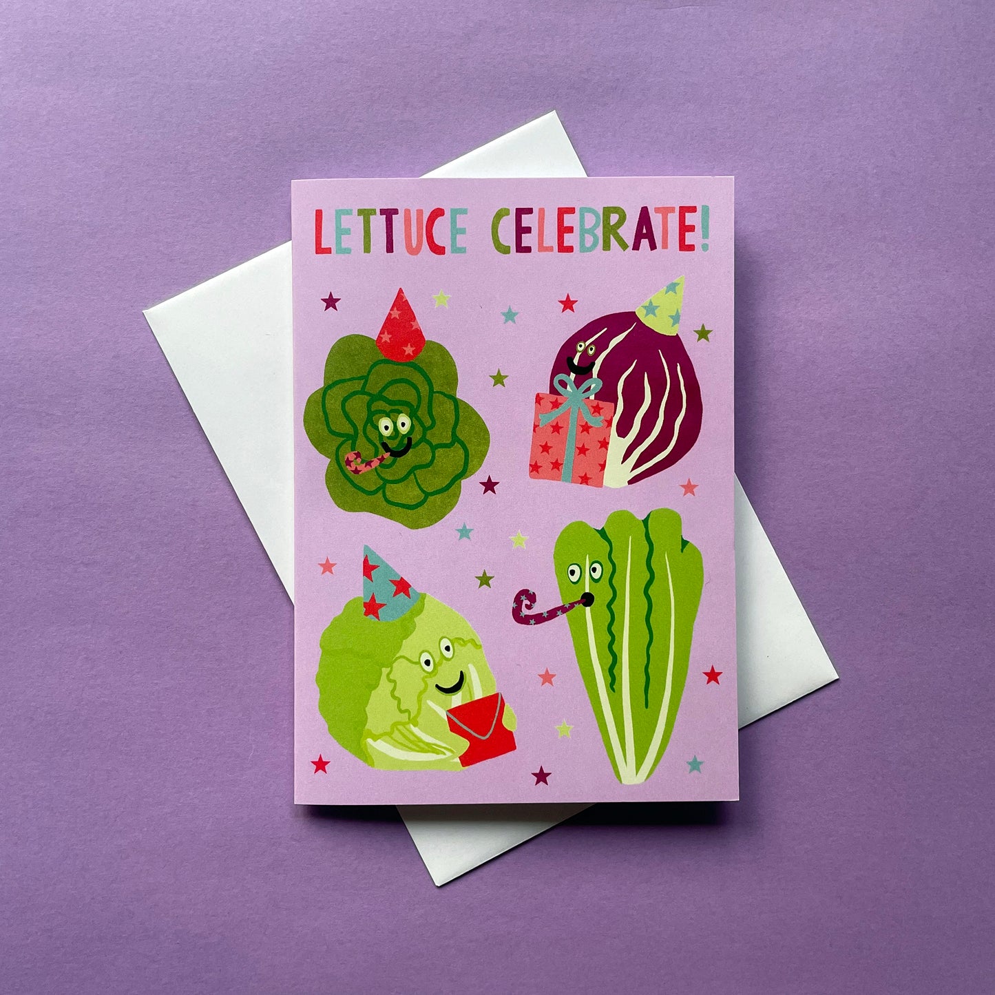 Greeting card with cartoon lettuce characters and 'Lettuce Celebrate!' text on a purple background