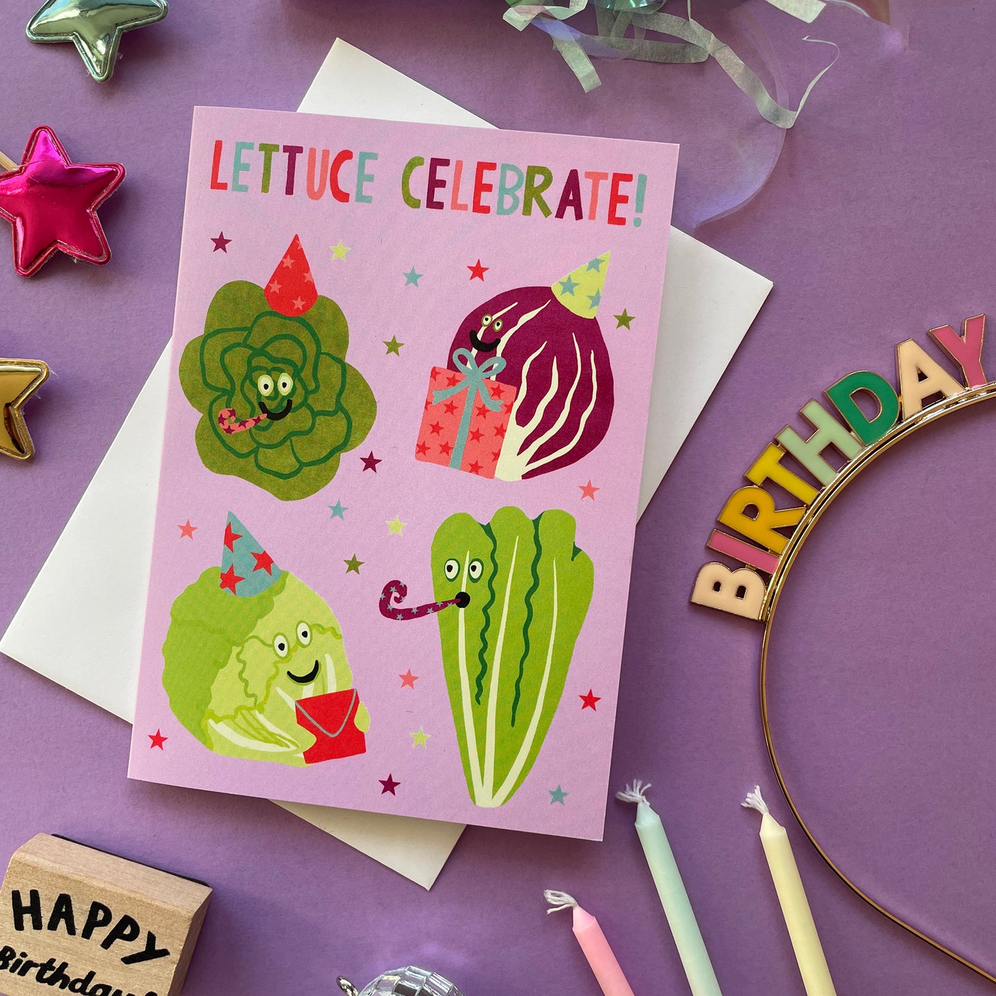 Birthday card with lettuce illustrations on a purple background with birthday decorations.