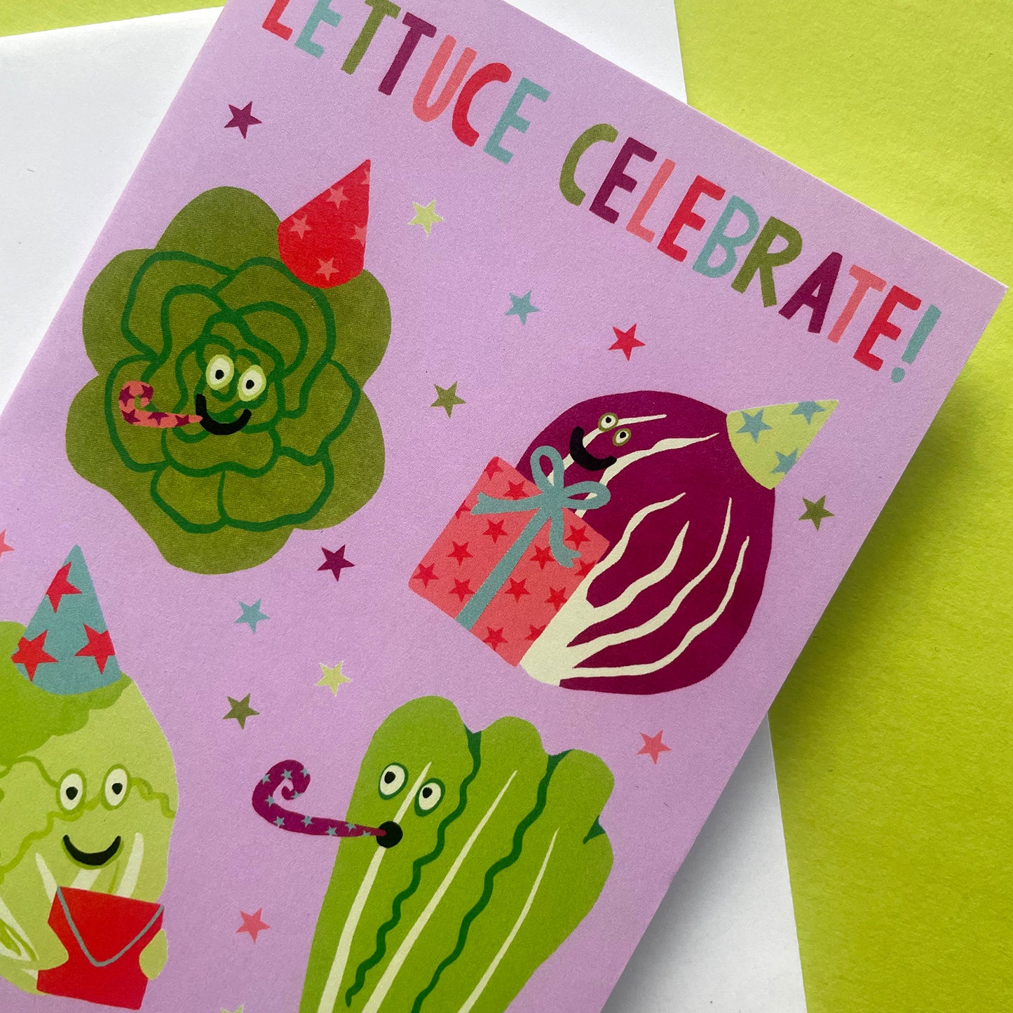Greeting card with cartoon lettuce characters and text 'Lettuce Celebrate!' on a green background