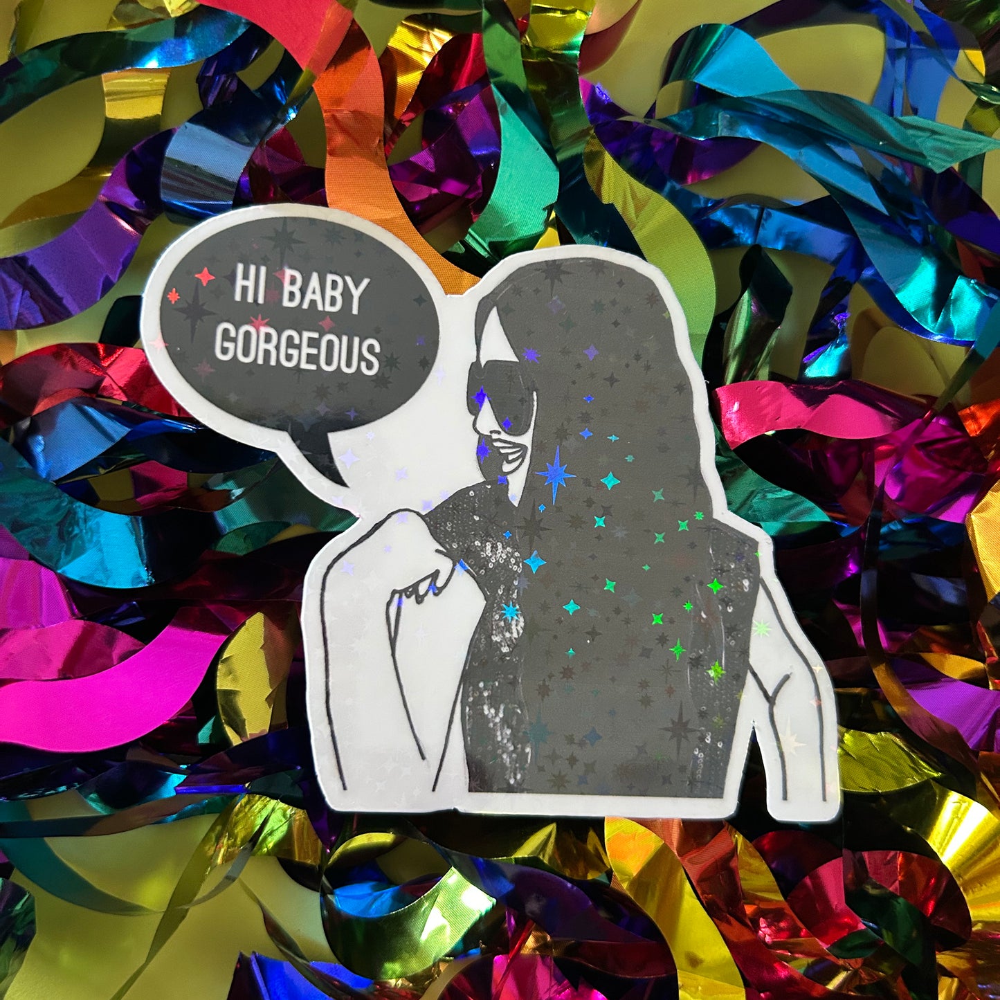 Sticker of a woman with a speech bubble saying 'Hi Baby Gorgeous' on a colorful confetti background