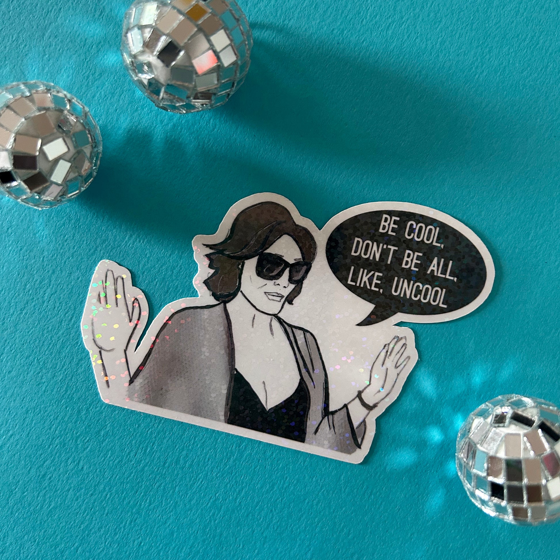 Sticker of Luann from RHONY with sunglasses and a speech bubble on a blue background with disco balls.