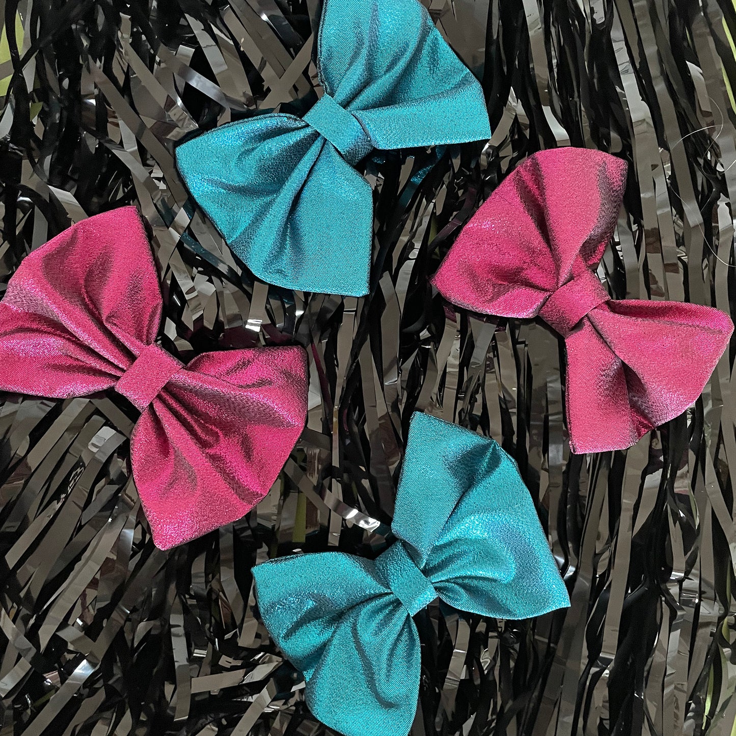 Image shows a blue metallic hair bow made from high quality lamé fabric.