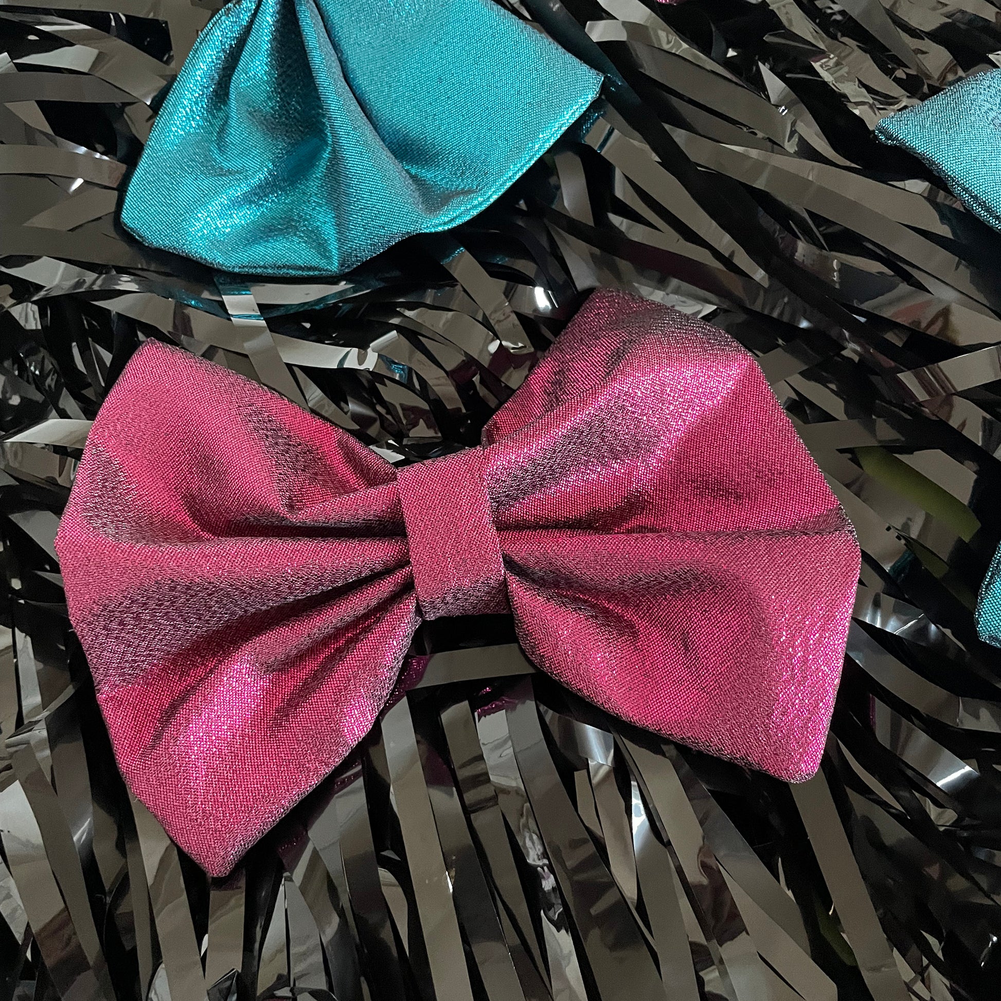 Image shows a pink, metallic hair bow made from high quality lamé fabric.