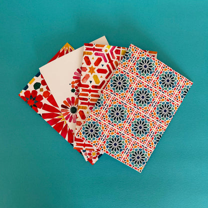 Colourful Moroccan patterned note cards on a teal background