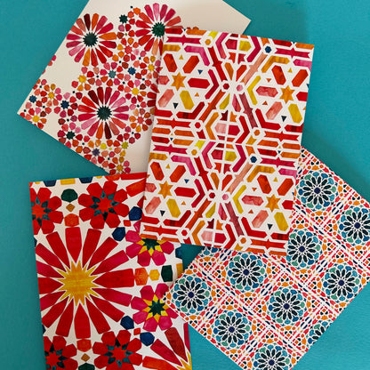 Colourful patterned paper sheets on a teal background