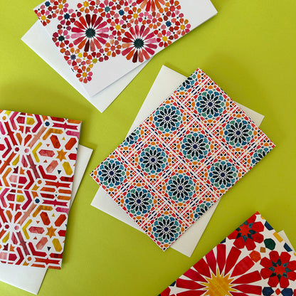 Colourful patterned greeting cards on a green background