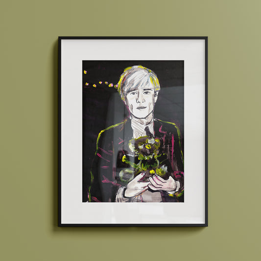 Image shows a framed portrait of artist Andy Warhol holding a teddy bear. The artwork is painted in black and white with  neon pink and yellow highlights.