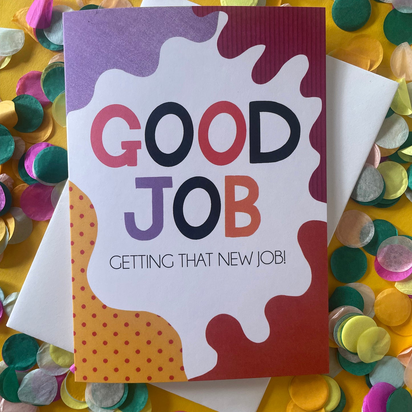 Image shows a bright greetings card with colourful, abstract shapes around the edge and the wording "Good Job getting that new job!"