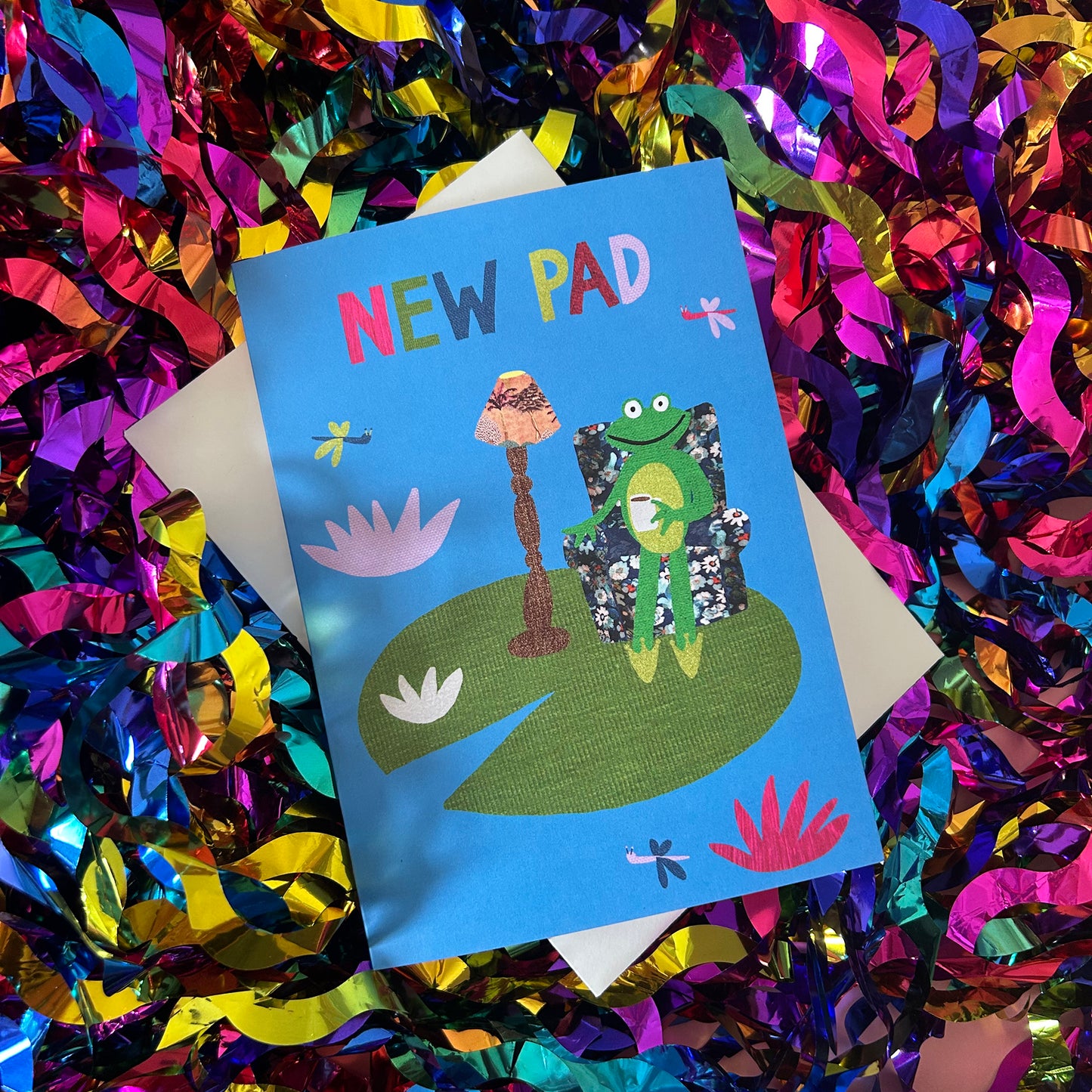 Greeting card with a frog design on a colorful confetti background