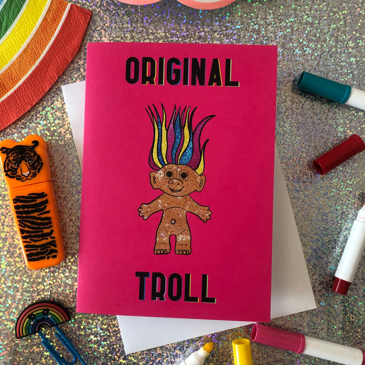 Image shows a bright Pink Greetings Card featuring an illustration of a nineties troll doll