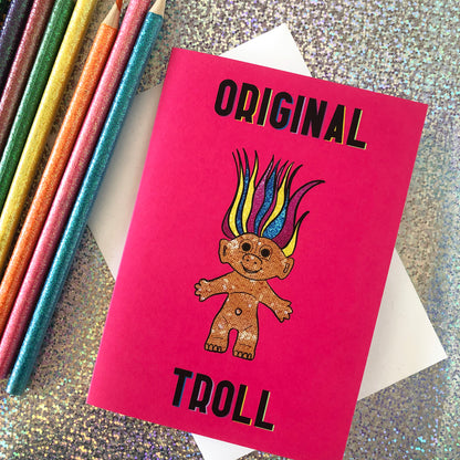 Image shows a bright Pink Greetings Card featuring an illustration of a nineties troll doll