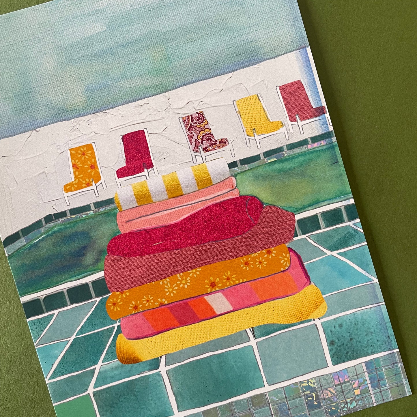 Close up detail of an illustration of a poolside featuring a stack of colourful towels and some chairs.