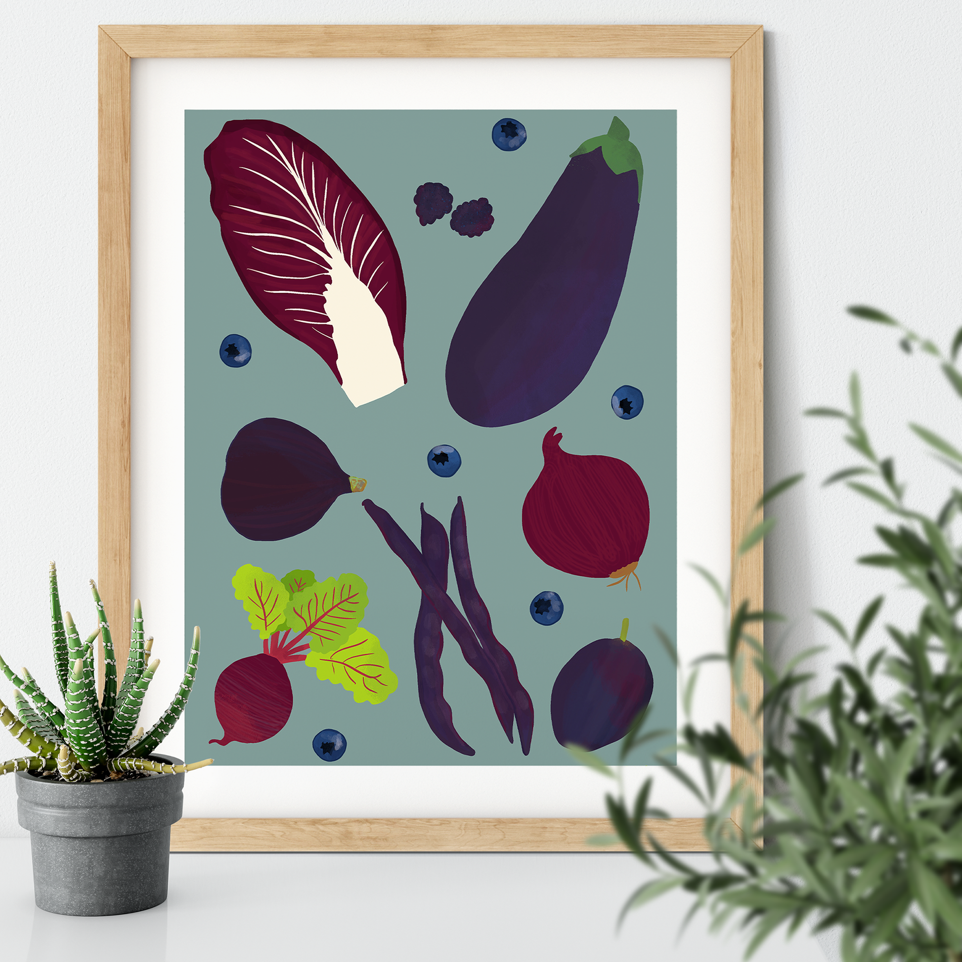 Image of a framed art print of purple fruit and vegetables on a pale indigo background.