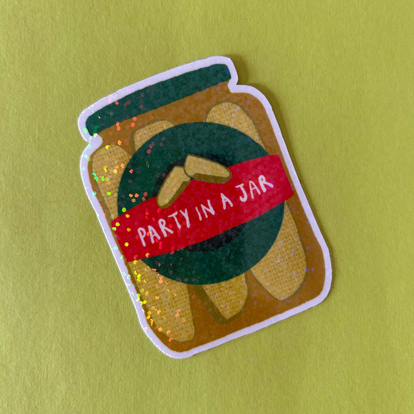 Sticker of a jar with a red label saying 'Party in a Jar' on a green background