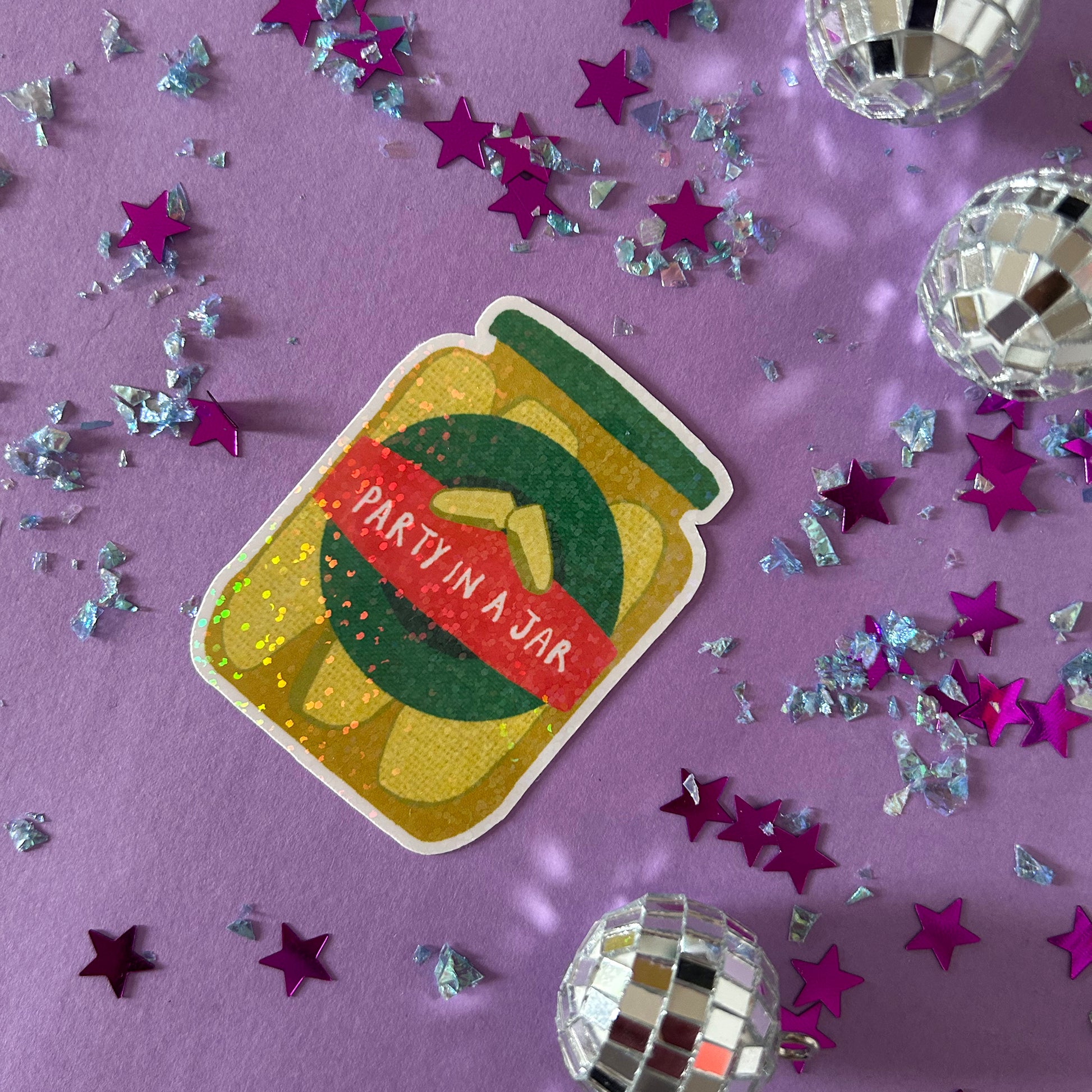 Sticker with 'Party in a Jar' design on a purple background with star-shaped confetti and disco balls.