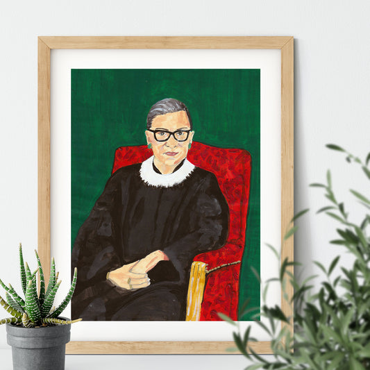 Image of a framed art print of a portrait of Ruth Bader Ginsburg sitting on a red chair with a green background, originally painted in acrylics 