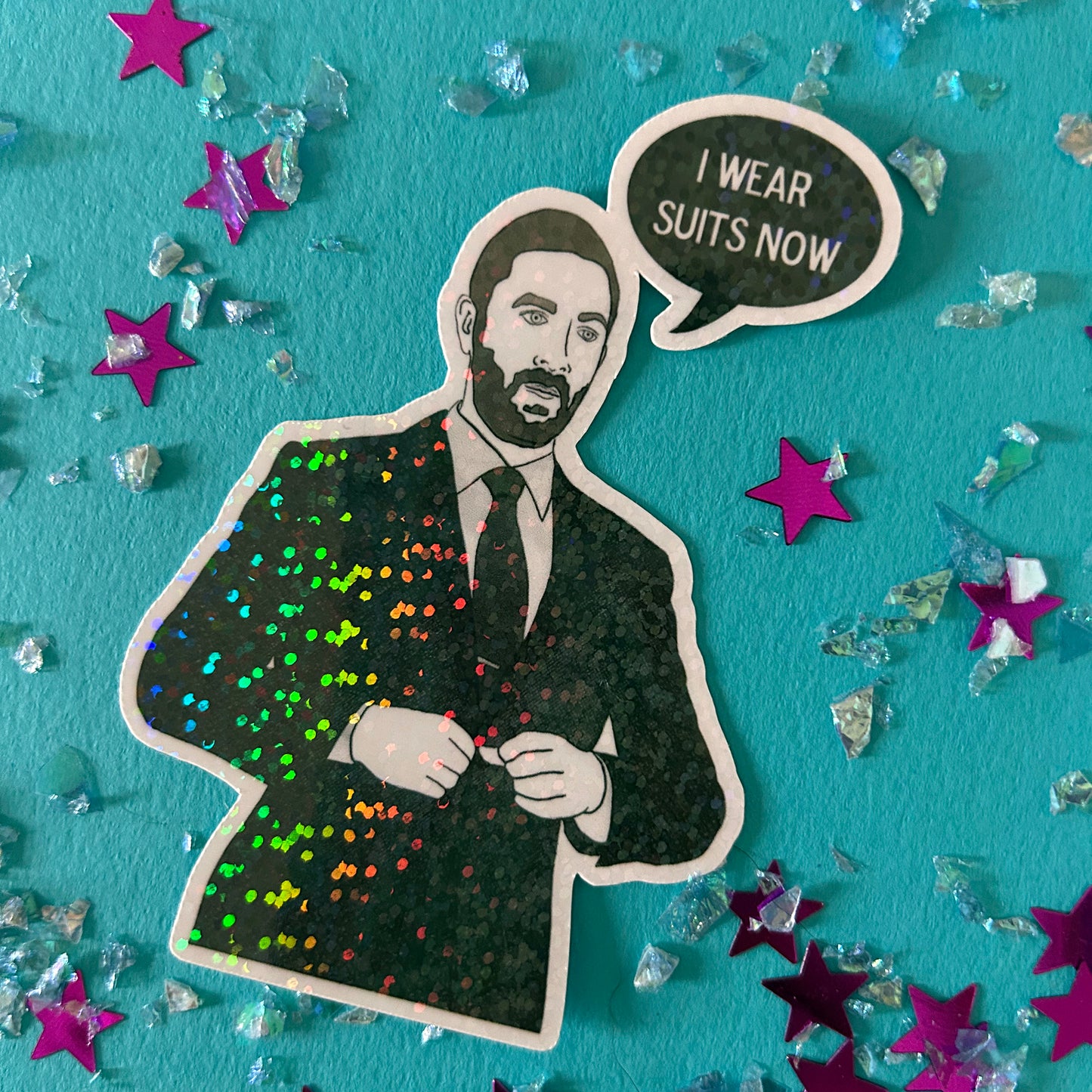 Sticker of Richie from The Bear with the caption I wear suits now on a blue background with stars and crystals.