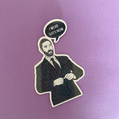 Sticker of Richie from The Bear in a suit with a speech bubble saying 'I wear suits now' on a purple background