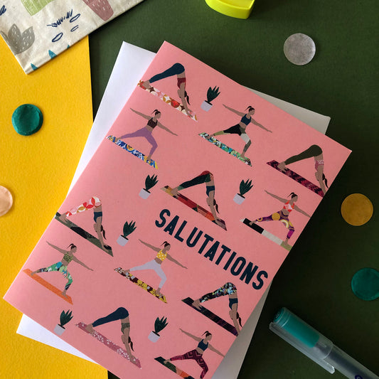 Image shows an everyday greetings card that says 'salutations' and features a fun pattern of women doing yoga poses on colourful yoga mats