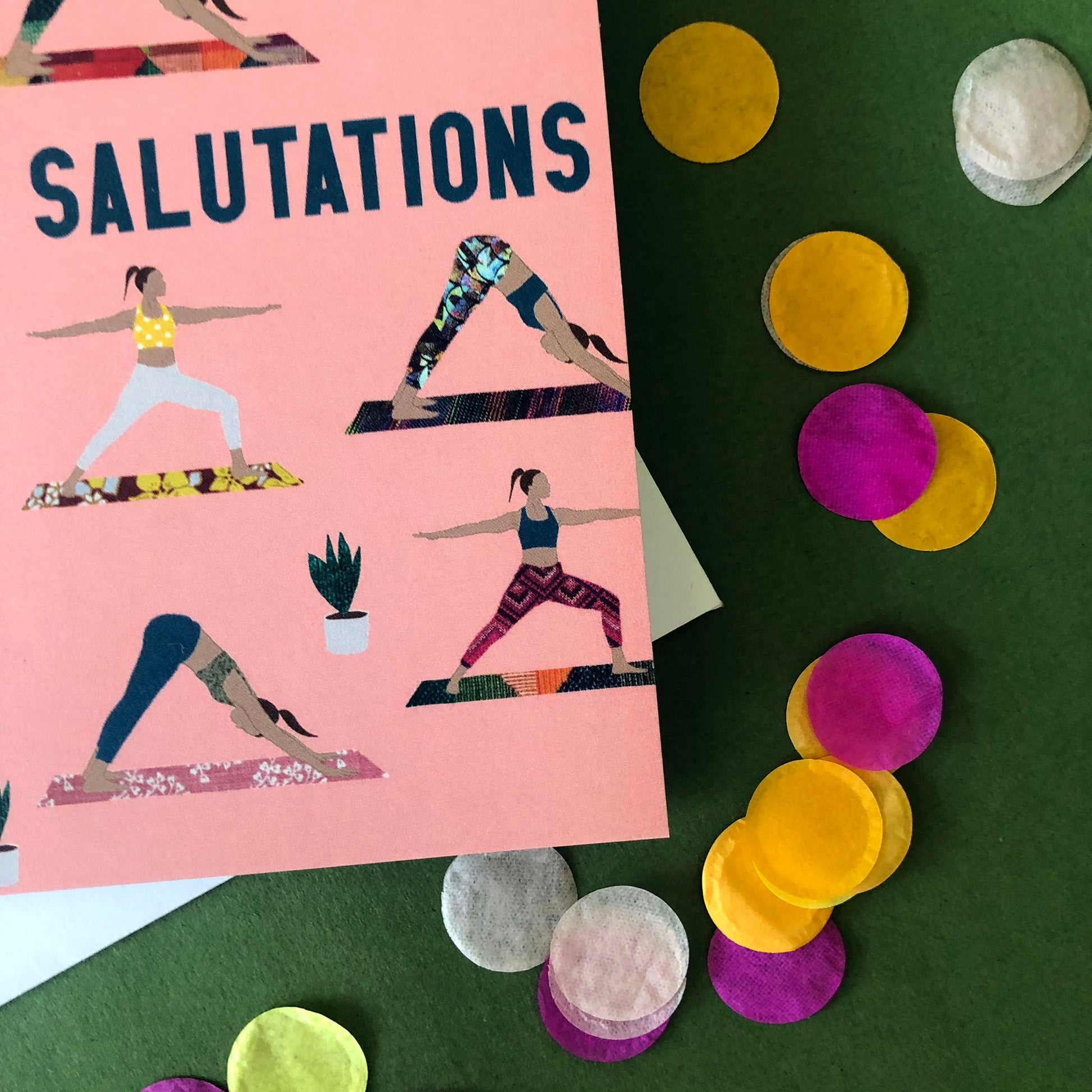 Image shows an everyday greetings card that says 'salutations' and features a fun pattern of women doing yoga poses on colourful yoga mats