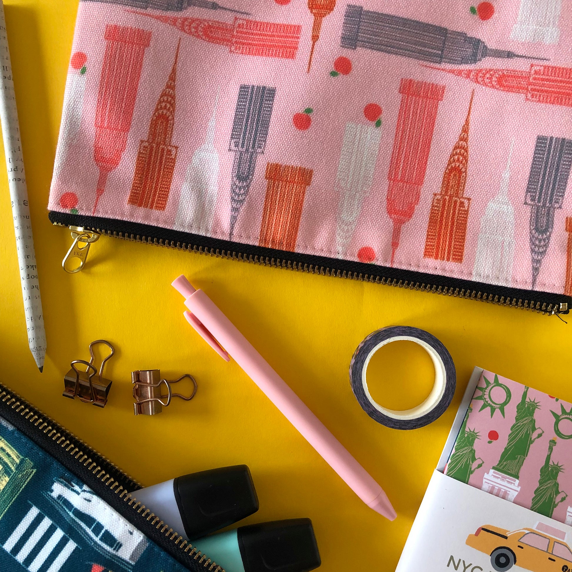 Handy zip pouch in pastel pink featuring a unique design inspired by the skyscrapers of NYC 