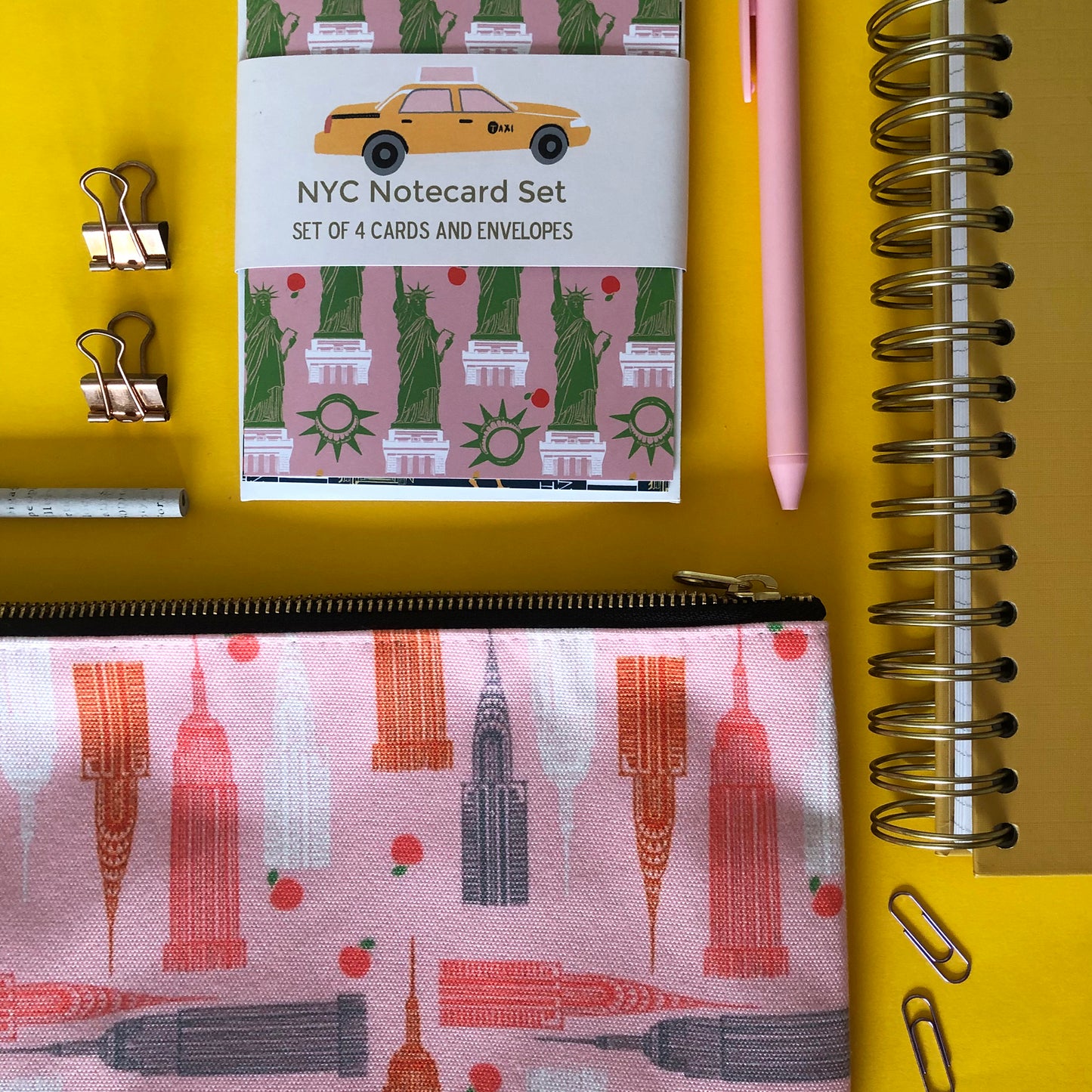 Handy zip pouch in pastel pink featuring a unique design inspired by the skyscrapers of NYC 