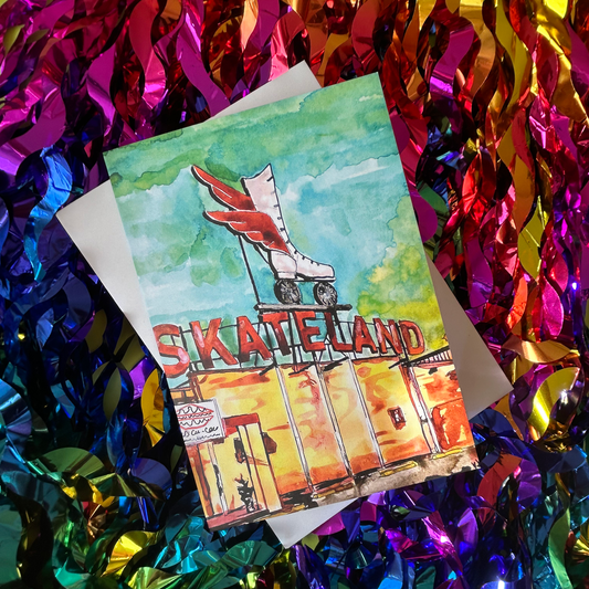 Card with roller skates and 'Skate Land' text on a colourful tinsel background
