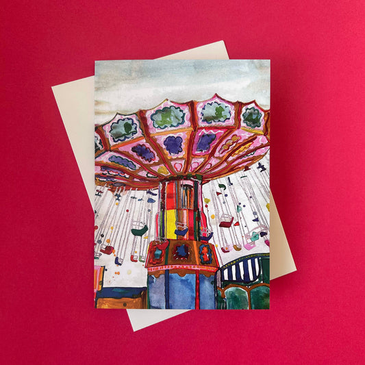 Greeting card with a colourful carousel design on a red background