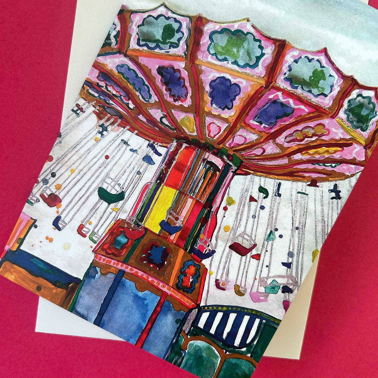 Greeting card with a colourful carousel design on a red background