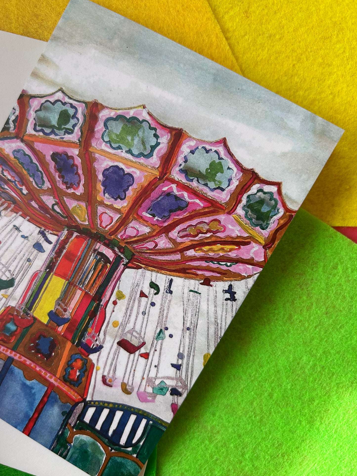 Greeting card with a colourful carousel design on a green and yellow background