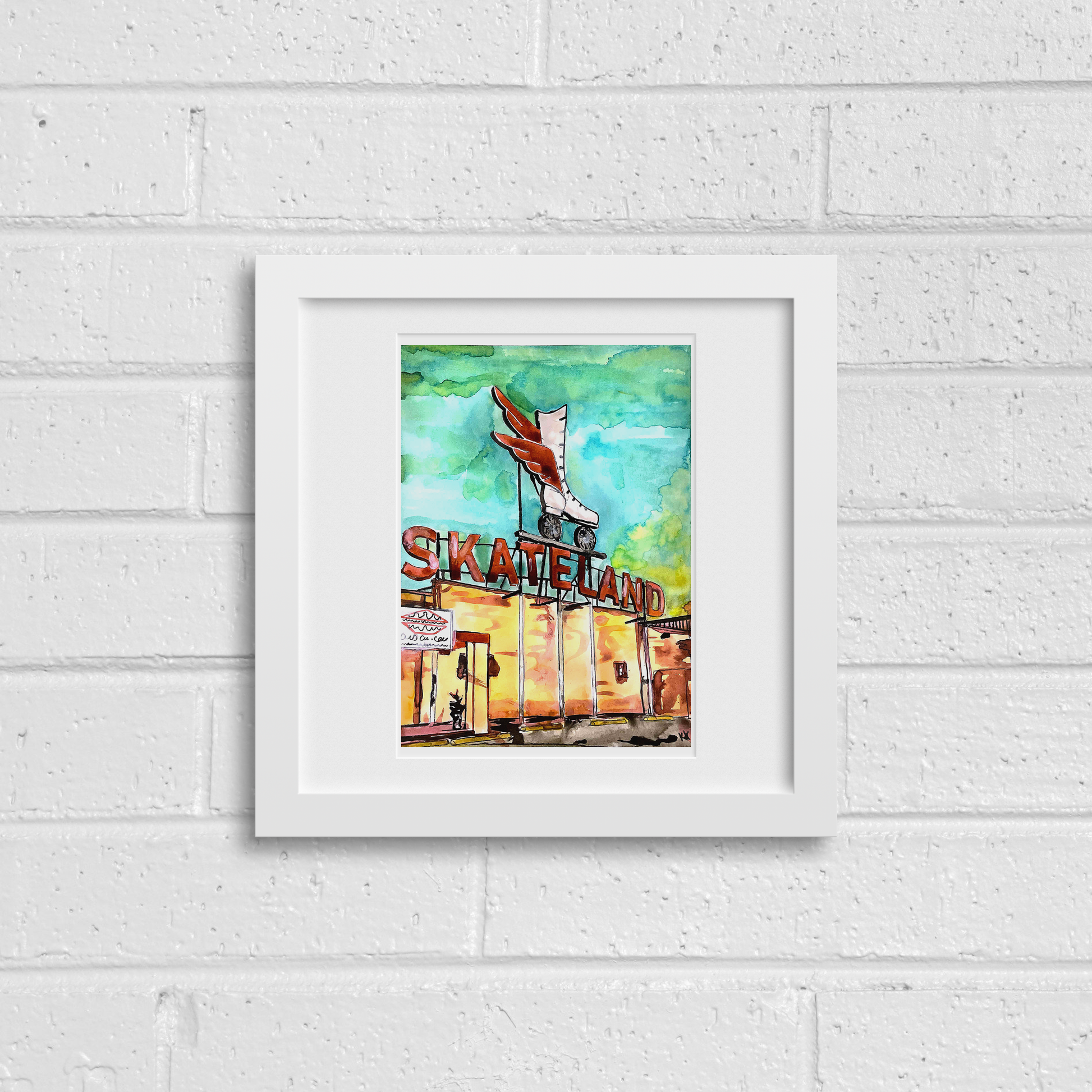 Framed artwork of a skateland scene on a white brick wall