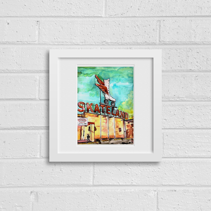 Framed artwork of a skateland scene on a white brick wall