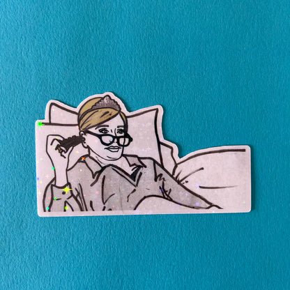 Sticker of Sonja from RHONY watching TV in bed wearing a tiara on a blue background