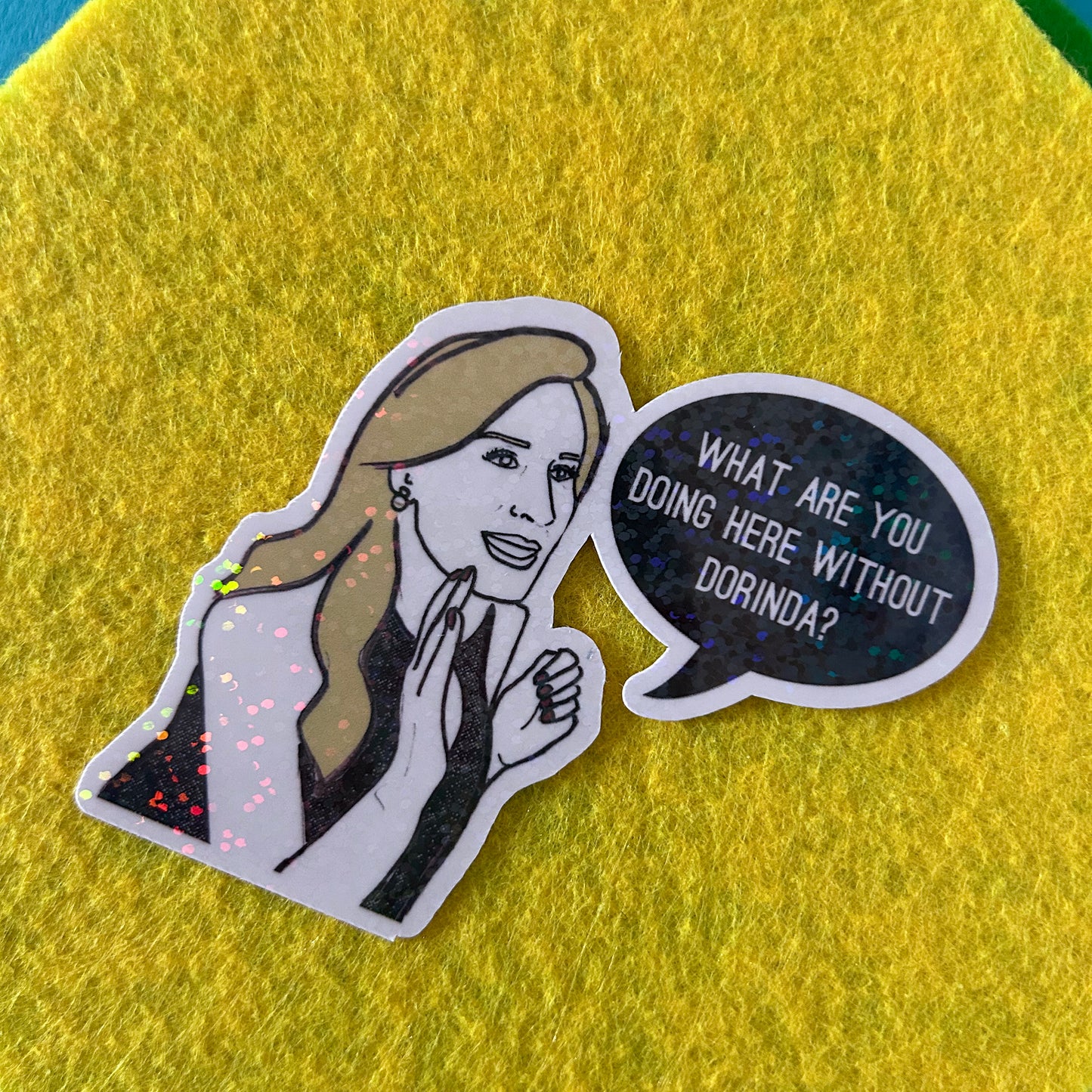 Sticker of a woman with a speech bubble asking 'What are you doing here without Dorinda?' on a yellow background